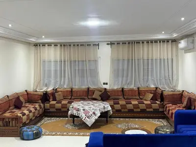 a living room with a couch and a table at Apartment in downtown Fez in Fès