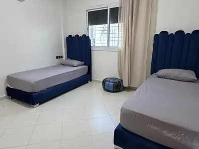 a bedroom with two beds and a window at Apartment in downtown Fez in Fès