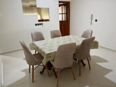 a dining room table with six chairs around it at Apartment in downtown Fez in Fès