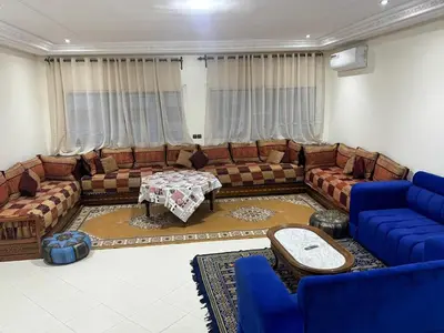 a living room with couches and a table at Apartment in downtown Fez in Fès