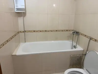 a bathroom with a bath tub and a toilet at Apartment in downtown Fez in Fès