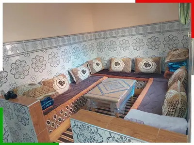 a living room with a couch and a table at Central apartment for families near the waterfall in Azilal