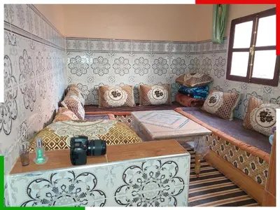 a room with a bed with pillows on it at Central apartment for families near the waterfall in Azilal