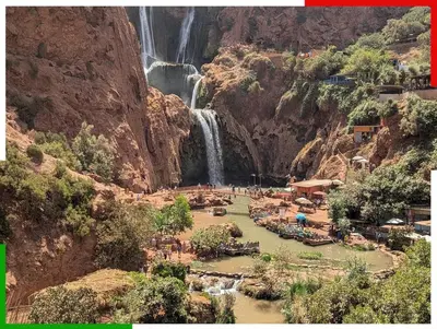 a view of a waterfall and a resort in a canyon at Central apartment for families near the waterfall in Azilal