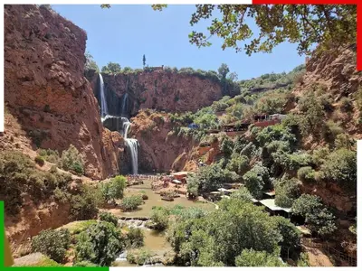 a waterfall in the middle of a canyon with trees at Central apartment for families near the waterfall in Azilal