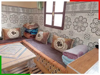 a couch with pillows on it in a room at Central apartment for families near the waterfall in Azilal