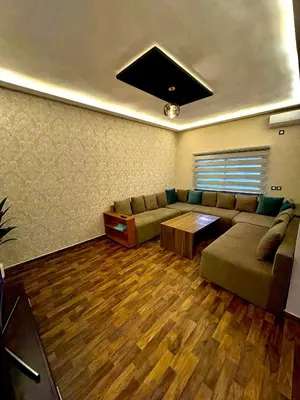 a living room with a couch and a table at Oasis Suite in Fès