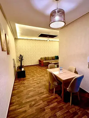 a conference room with a table and chairs and a couch at Oasis Suite in Fès