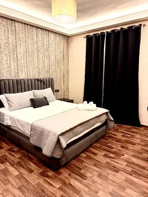 a bedroom with a large bed with black curtains at Oasis Suite in Fès