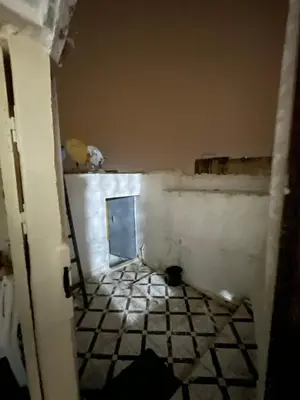 a room with a tile floor and a door at Dar charfa in Fès