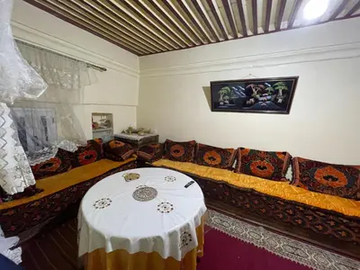 a living room with a couch and a table at Dar charfa in Fès