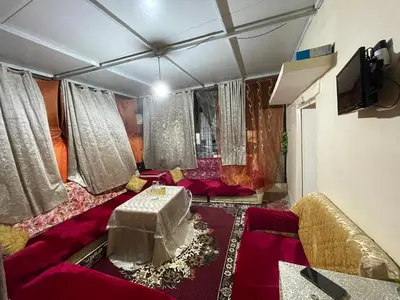 a living room with a couch and a table at Dar charfa in Fès