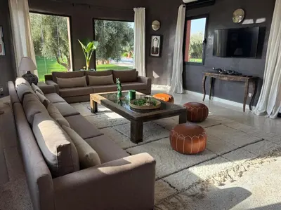 a living room with a large couch and a table at Villa Chocolat in Marrakech