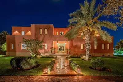 a house with a palm tree in front of it at Villa Chocolat in Marrakech