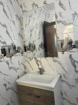 a bathroom with a sink and a mirror at Appartement Diyar Saiss in Meknès