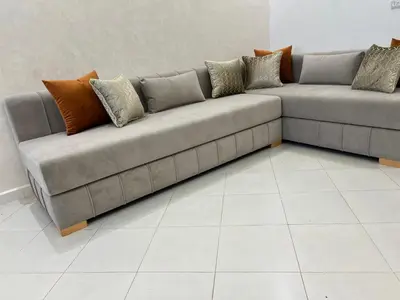 a couch with pillows on it in a room at Appartement Diyar Saiss in Meknès