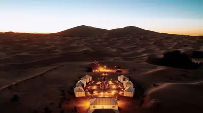 an aerial view of a desert with tents in the sand at Azalai Haven Camp in Merzouga