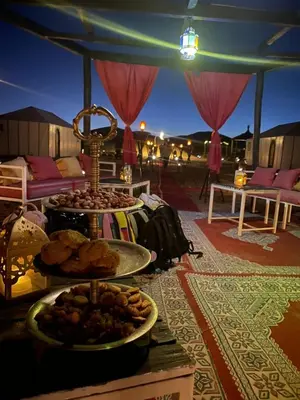 a table with a buffet of food in a tent at Azalai Haven Camp in Merzouga