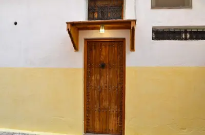 a wooden door on the side of a building at dar andalosse fes in Fès