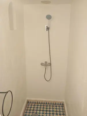 a shower in a bathroom with a tiled floor at dar andalosse fes in Fès