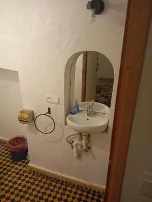 a bathroom with a sink and a mirror at dar andalosse fes in Fès