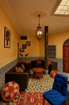 a living room with a couch and a fireplace at Riad jnan lward in Fès