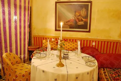 a table with a candle on it in a room at EL Ghalia in Fès