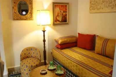a room with a bed and a chair and a table at EL Ghalia in Fès