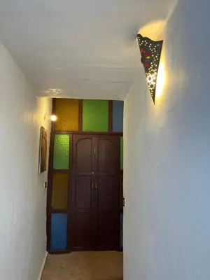 a kite hanging from a wall next to a door at Riad Sahara sol in Fès