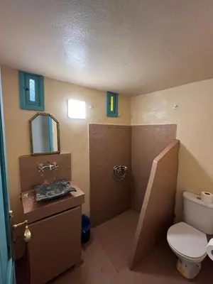 a bathroom with a toilet and a sink and a mirror at Riad Sahara sol in Fès