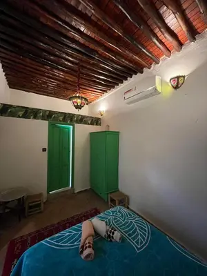 a person laying on a bed in a room at Riad Sahara sol in Fès