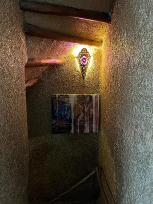 a stairway with a stained glass window and a light at Riad Sahara sol in Fès