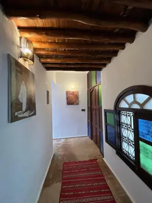 a hallway with white walls and a ceiling with a window at Riad Sahara sol in Fès