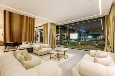 a living room with white couches and a table at Hidaya Villa - Heated Pool, Padel , Spa & Gym in Najem