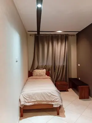 a bed in a room with a curtain at Annakhil 30 in Oulad Akkou