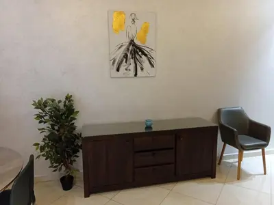 a room with a wooden cabinet and a plant at Annakhil 30 in Oulad Akkou