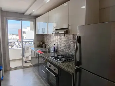 a kitchen with a stainless steel refrigerator and a window at Annakhil 30 in Oulad Akkou