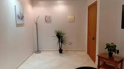 a hallway with a potted plant on a wall at Annakhil 30 in Oulad Akkou