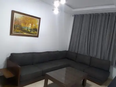 a living room with a couch and a table at Touahri C TW01 Apartment - Centre in Oulad Akkou
