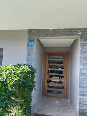 a door to a building with wine bottles at Beach-front paradise with parking and pool in Oulad Akkou