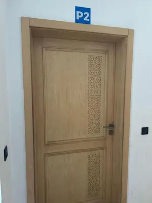 a wooden door with a parking sign above it at Beach-front paradise with parking and pool in Oulad Akkou