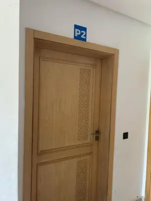 a door with a parking sign on top of it at Beach-front paradise with parking and pool in Oulad Akkou