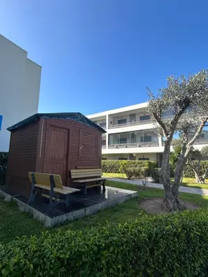 a bench next to a building with a building at Beach-front paradise with parking and pool in Oulad Akkou