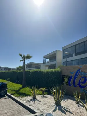 a parking lot in front of a building at Beach-front paradise with parking and pool in Oulad Akkou