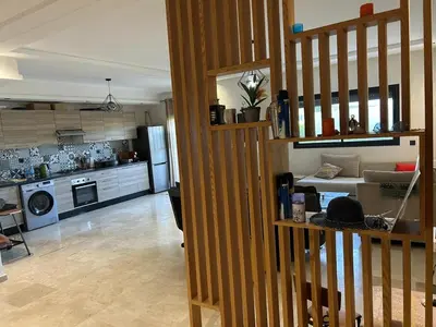 a room with a kitchen and a living room at Beach-front paradise with parking and pool in Oulad Akkou