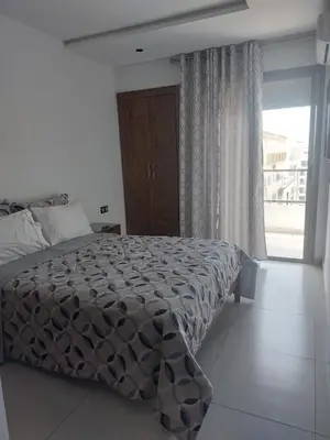a bedroom with a bed and a large window at Al Anouar B40 in Oulad Akkou