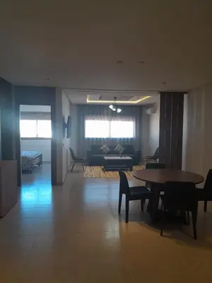a living room with a table and a couch at Al Anouar B40 in Oulad Akkou