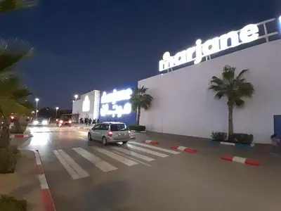 a car parked in a parking lot in front of a building at Serene City Escape in Meknès