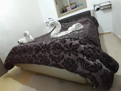 a bed with two stuffed swans on top of it at Serene City Escape in Meknès