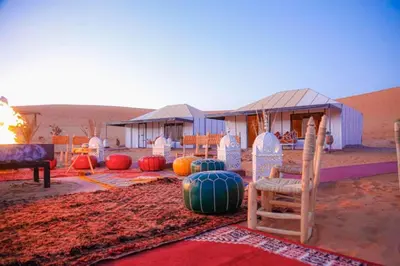 a tent in the middle of the desert with lots of pumpkins at merzouga asamer in Merzouga